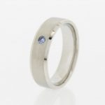 Platinum wedding ring set with a sapphire.