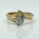 18ct wedding band fitted against an antique engagement ring