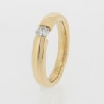 18ct gold band with a 'Tension' set diamond