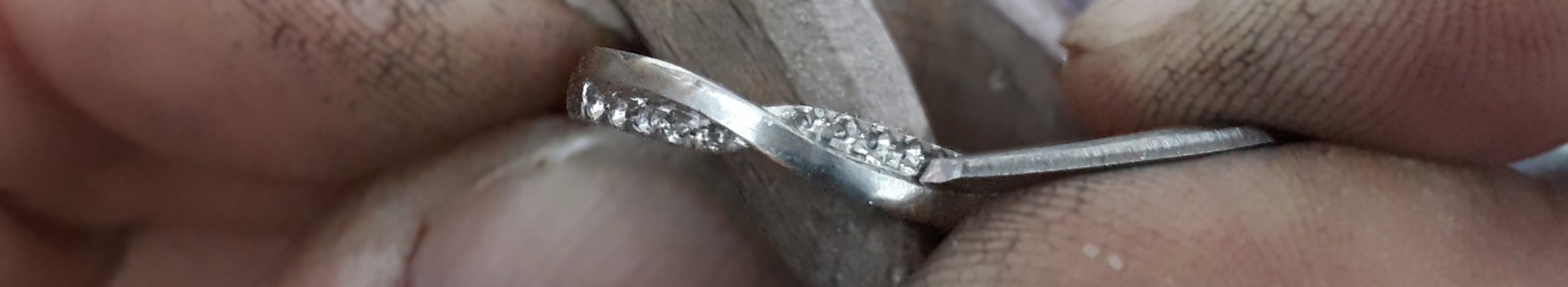 Hand settng diamonds into a weddding ring